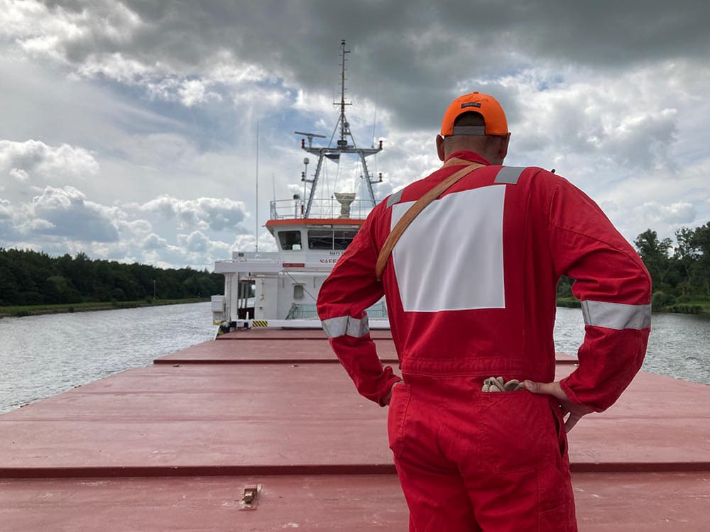 Seafearer standing on the loading are of a vessel